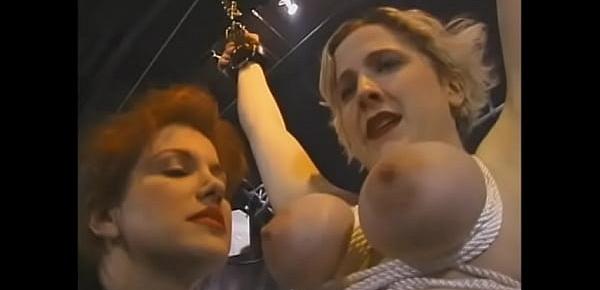  Big booty redhead domina gives a hard spanking to naughty blonde in the basement